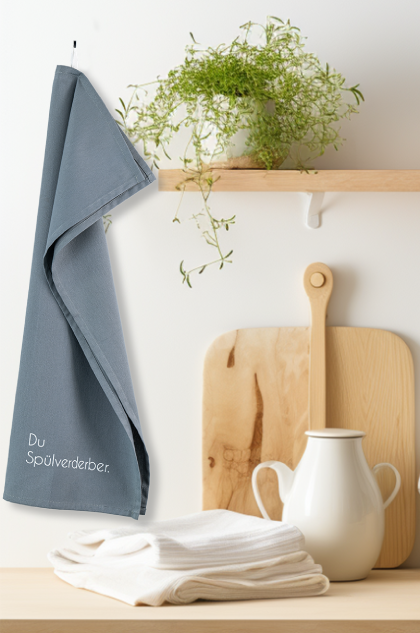 Towel in a kitchen with a plant on a shelf and a cutting board